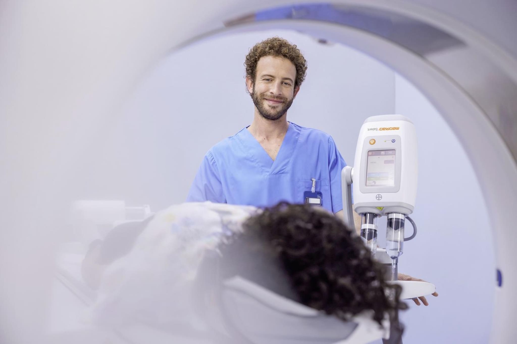 Radiographer prepares patient for scan